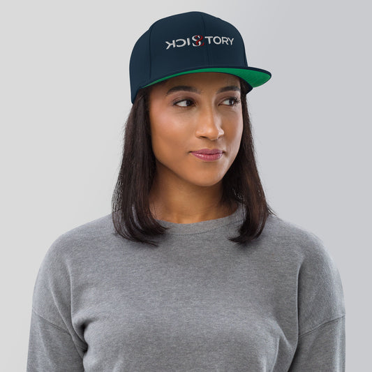 Woman wearing a navy Sick Story snapback cap with embroidered logo and green undervisor